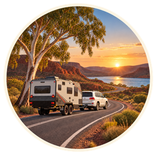 Caravan and tow vehicle travelling through a red-rock Australian landscape at sunset